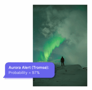 On a popout there is an example text message of an aurora alert from Aurora Admin. Its layered over an image of a person looking at the aurora in the night sky.