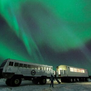 A tour bus under the northern lights in churchill